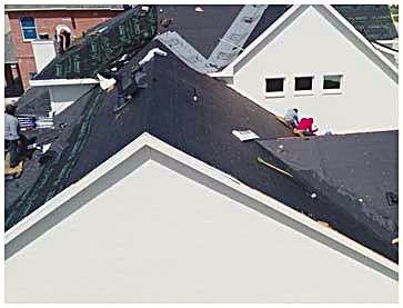 A roof part way through a job, underlayment down over the decking and shingles going on